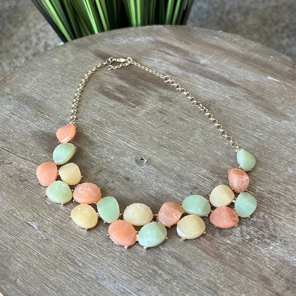 Muted colors and and gold statement necklace. Worn once.